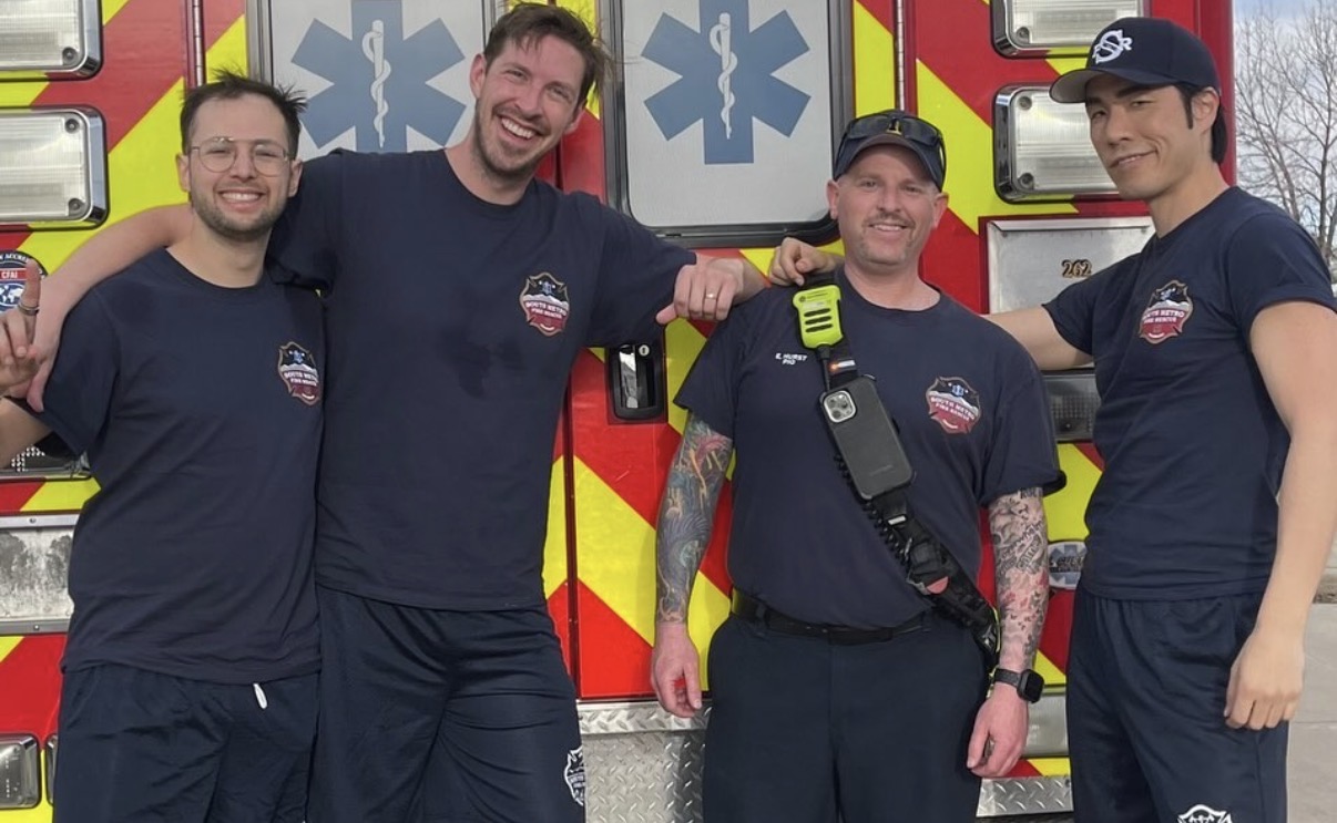 Eric Hurst with members of The Try Guys in front of a fire rescue vehicle